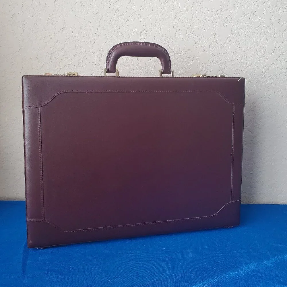 Burgundy leather attaché briefcase with a three-digit combination lock and gold-